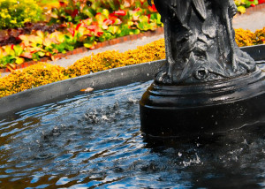 Close up of fountain water splashing into the pool.
