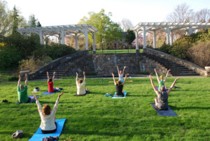 Visitors enjoying a yoga class in the Secret Garden.