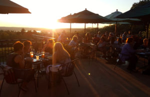 Visitors enjoying the sunset on the cafe patio