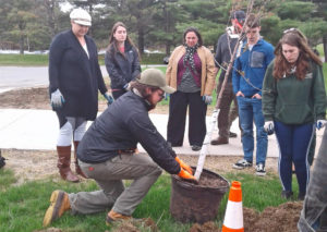 A group of college students works with the Garden to plant trees.