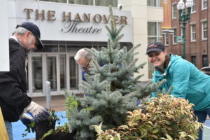 CEO Grace Elton and other garden staff and volunteers planting in front of the Hanover Theatre.