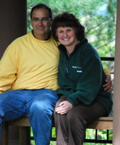 Two people sit and pose for a photo.