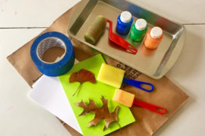 Paint and other art supplies to make leaf prints.