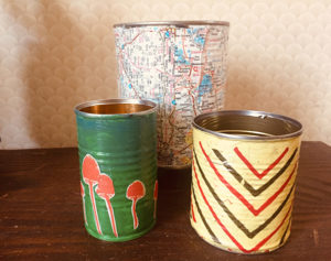 Tin cans become planters decorated with fun colors.