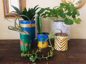 Tin cans become planters decorated with fun colors.