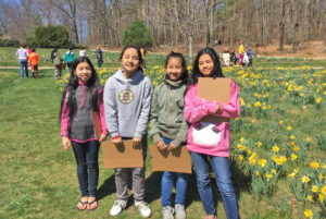 Four students from WRAP stand near the daffodil field