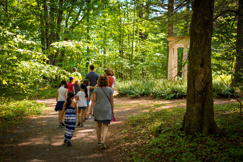 A group of visitors wander through the trails of the Inner Park in the summertime.