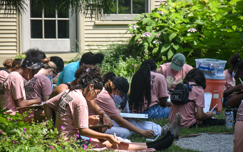 YouthGrow students work on an activity in the Cottage Garden.