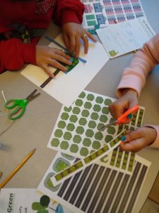 Two kids cutting out growing green activities