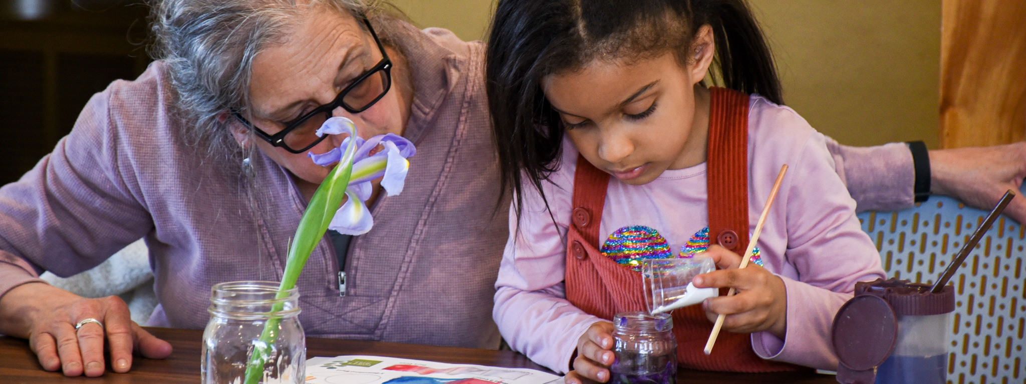 A child and her grandmother during a children's program