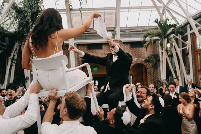 During a wedding reception in the Orangerie guests dance the hora.