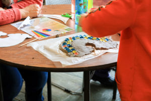 Children create rainbow crafts during February Vacation week.