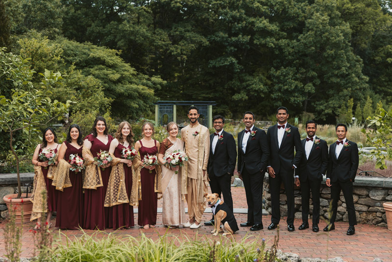 A couple and their wedding party pose in the Nadeau Garden.