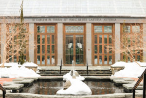 A snow covered, but cleared, Winter Garden showcases the turtle pond and the Orangerie in the background during winter at the garden.