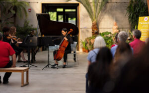 A group of musicians plays in the Limonaia as visitors sit and listen during Music in Bloom.