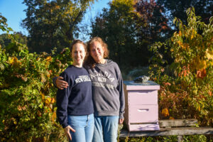 Mother and daughter near honeybee hive