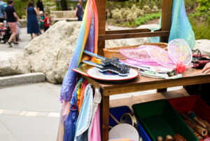 The dress up station is filled with a variety of fun dress up items like wings and foam swords.