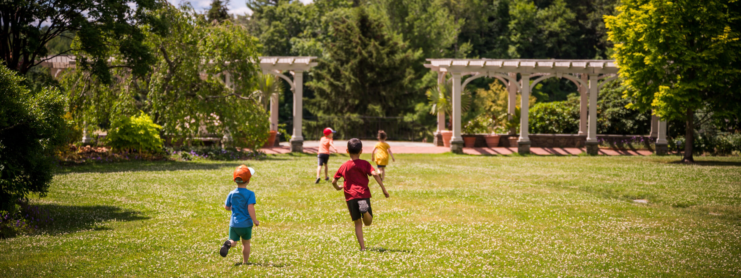 Children run through the Lawn Garden enjoying the summer.