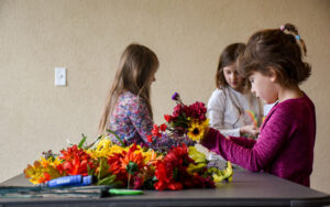Children pick out flowers to make floral crowns during April Vacation time.