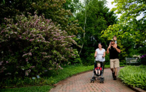 A family walks along the paths of the Lawn Garden.