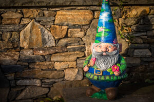 A Claude Monet gnome stands in the winter garden.