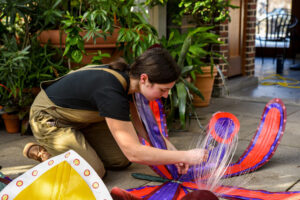 Molly Gambardella works on hanging up her orchid sculptures.