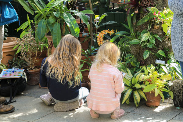 Two children sitting in the conservatory during self-guided field trips offered at the Garden.