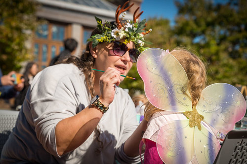 A young girl gets her face painted during Fairy Fest.