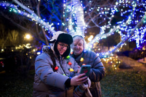 people smiling in festive lights