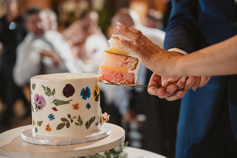 Newlywed cuts a petite floral wedding cake