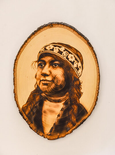 wood-burning portait of Dr. Gladys Iola Tantaquidgeon by Mia Frattura