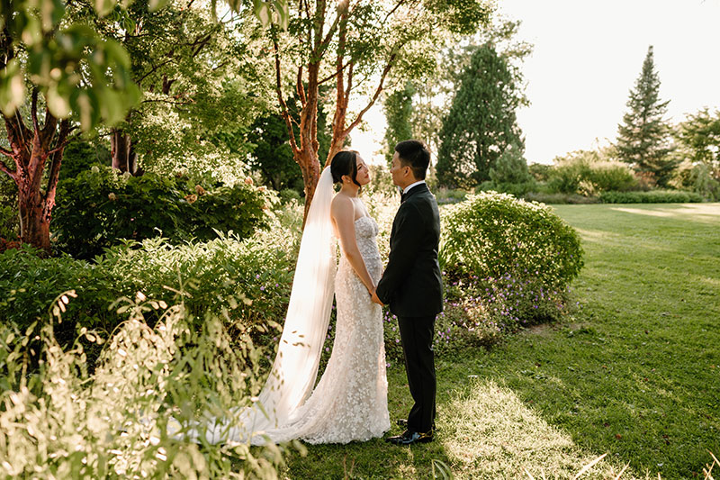 Couple holding hands on the lawn garden after for their wedding