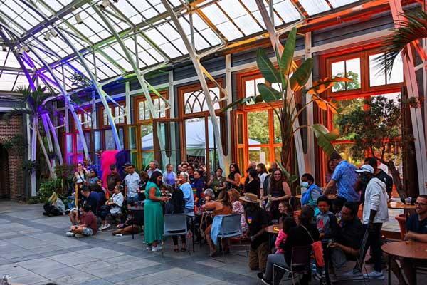 Pride event gathering uniquely set in a garden's conservatory