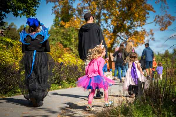 Children dressed as unicorns and young adults as dragons, at Enchanted Weekend event