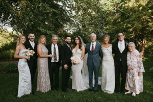 Lisa-Kirby-Gibbs-Ambassador-photo-opt Bride and Groom posing with family in a garden