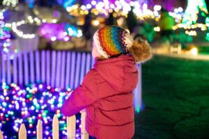 A child at Night Lights, a holiday lighting event at New England Botanic Garden