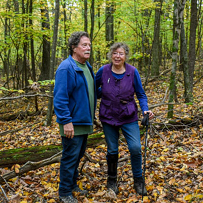 Lois Breault-Melican and Denis Melican in the forest