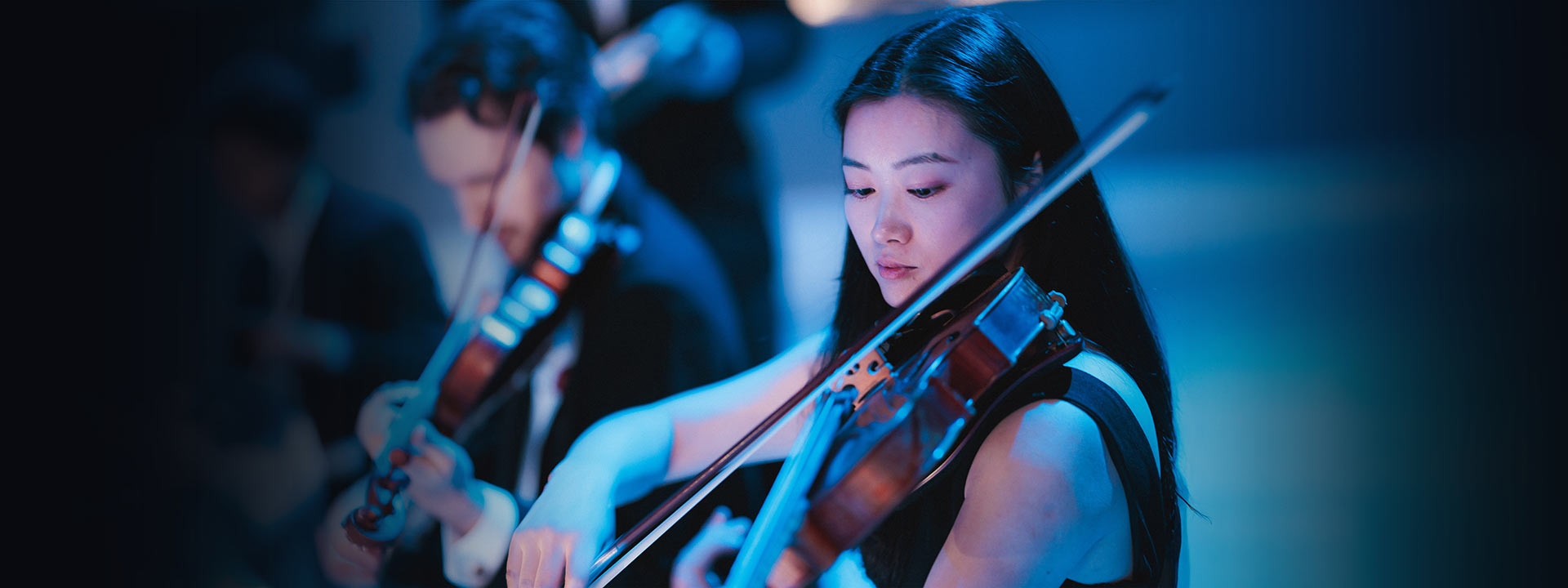 Close up of violinists playing a concert