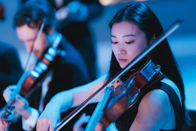 Close up of violinists playing a concert