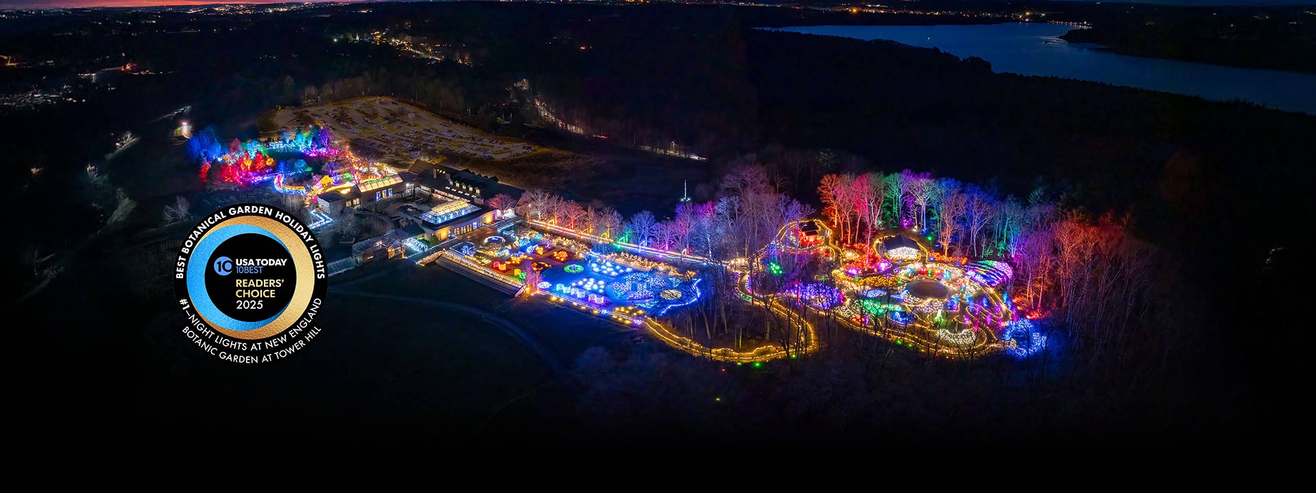 Aerial view of the garden at night during Night Lights with bright colorful flights contrasting the night sky