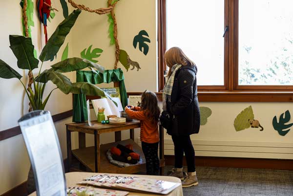 a child and with an adult reading in a classroom