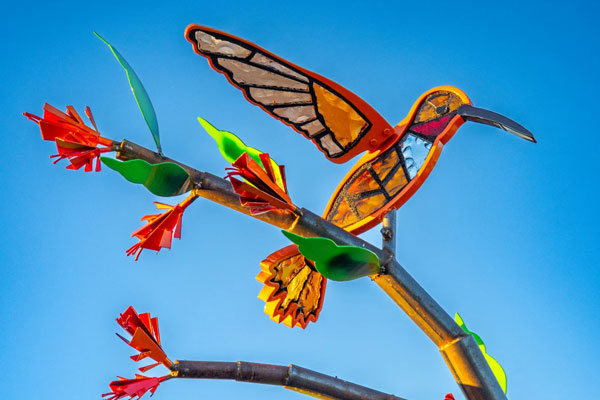 A mockingbird sculpture made of stained glass