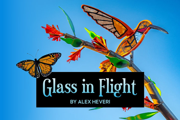 A mockingbird sculpture made of stained glass and steel.