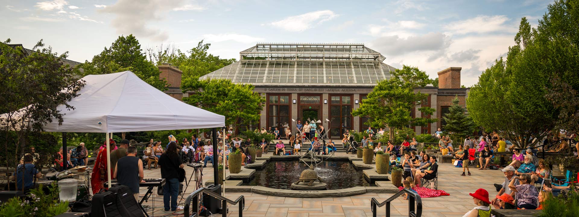 A gathering of visitors in the Winter Garden during the summer for a concert