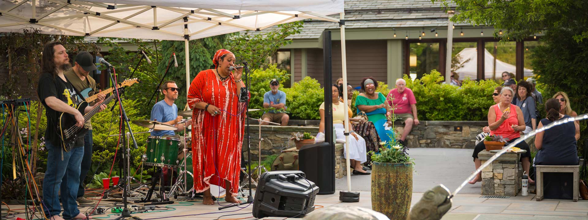 A band playing in the Winter Garden at New England Botanic Garden, during a summer evening