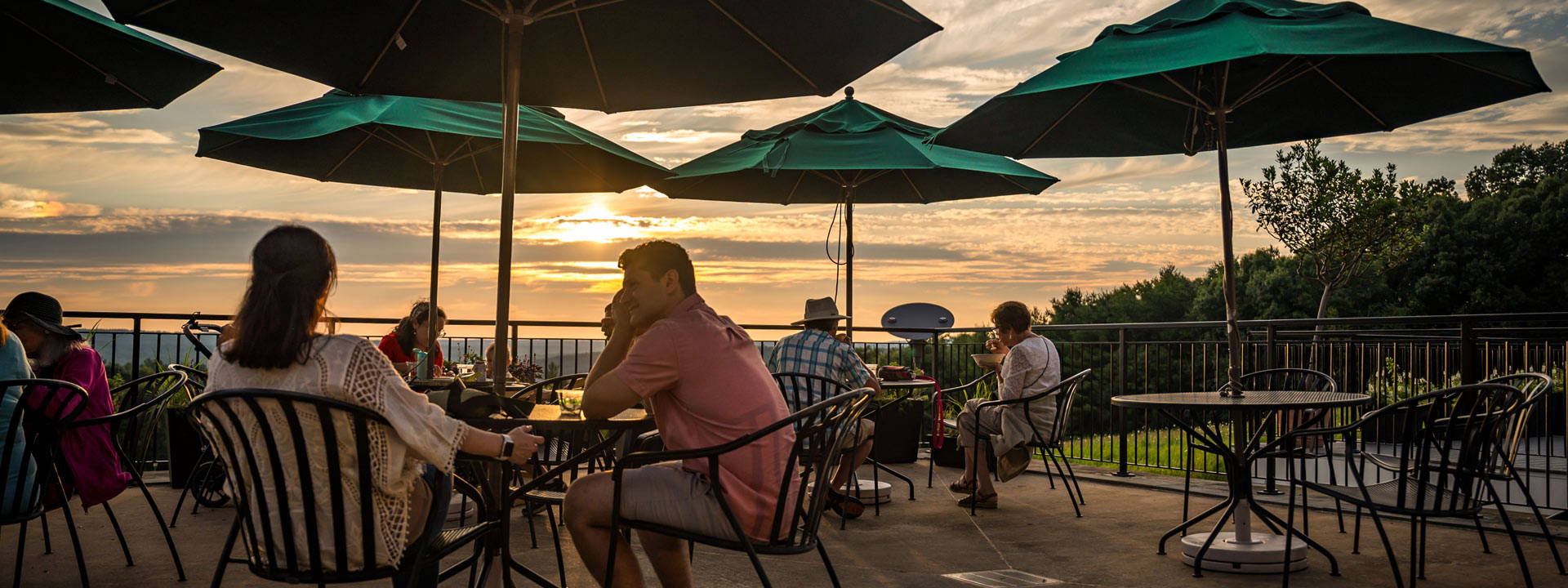 Visitors admiring the sunset on the terrace