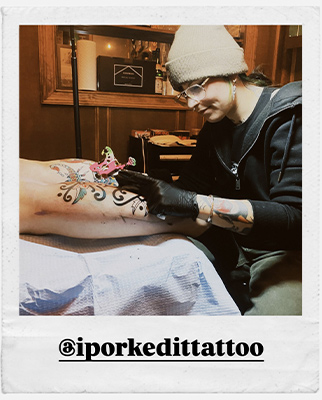 Tattoo artist, Grace, tattooing a calf