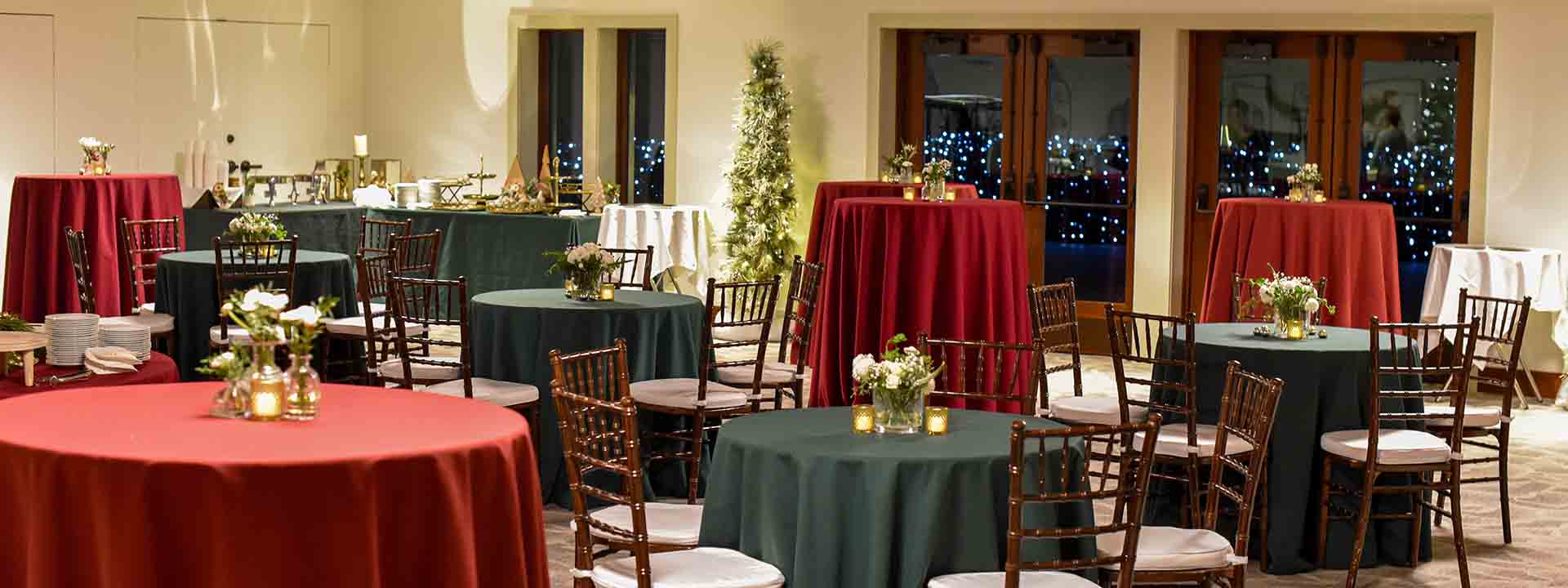 Holiday table set up with holiday trees and decor in the reservoir room