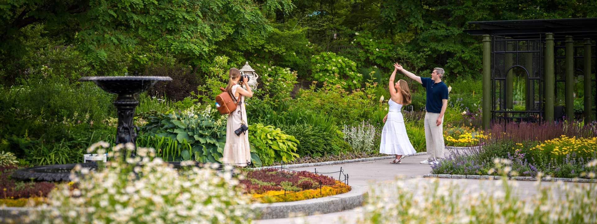 A photographer capturing a couple dancing in the Garden of Inspiration