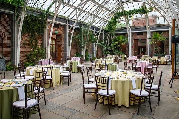 Fancy table and chairs set up for a social event in the Orangerie